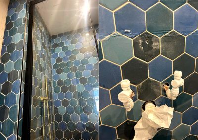 Blue hexagon shaped tiles being removed in preparation for a new shower installation