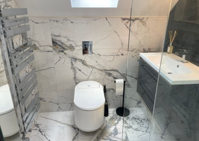 Luxury bathroom installation in Northampton using large format Italian 'marble effect' porcelain wall and floor tiles